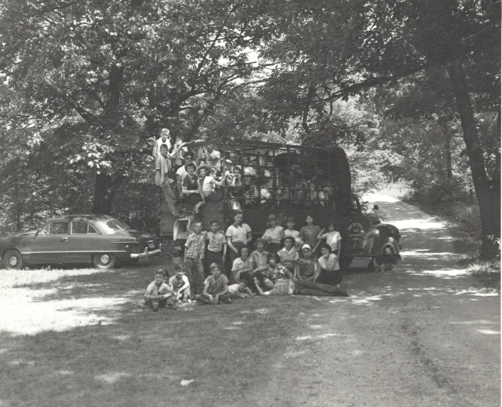 Off-The-Street Club campers with truck in wooded area