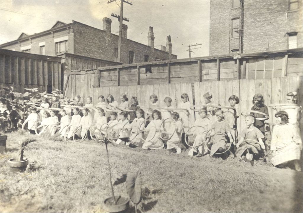 Miniature of Girls practicing with hoops in a yard