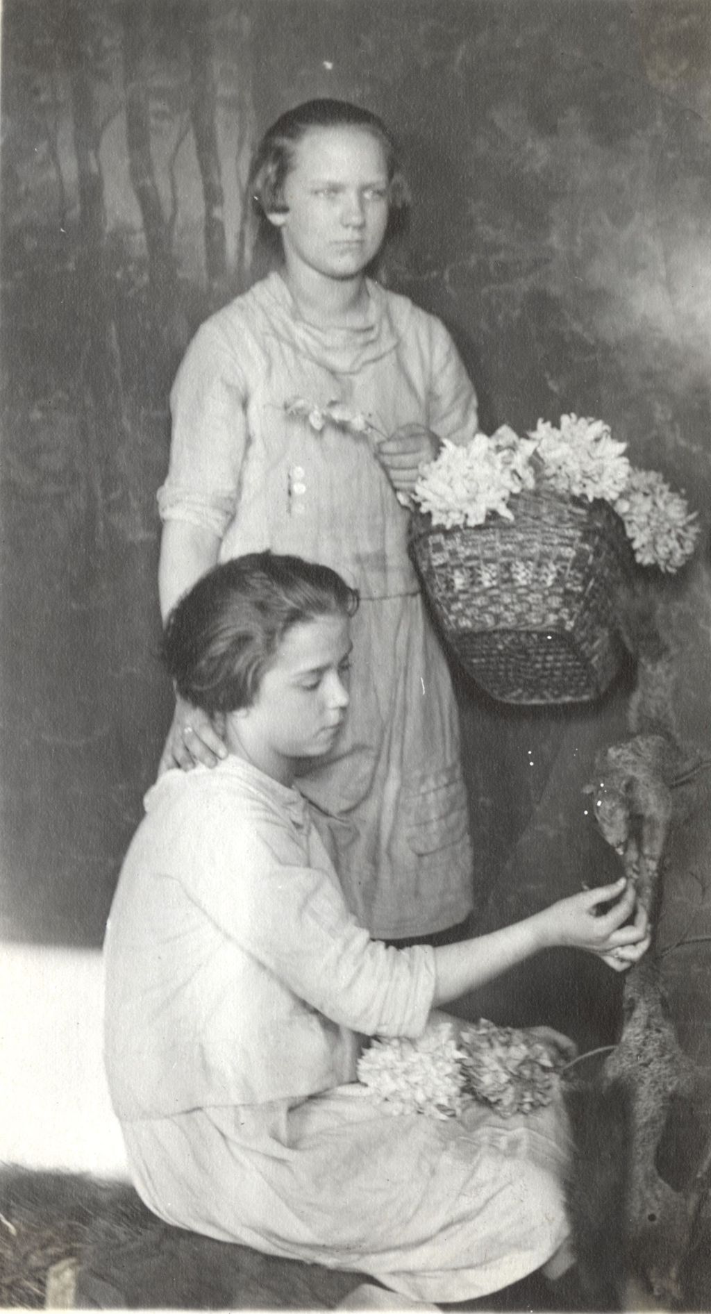 Miniature of Two girls with flowers inside room