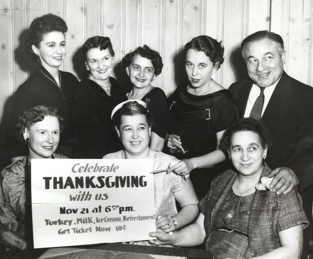 Mothers Club members with Thanksgiving sign
