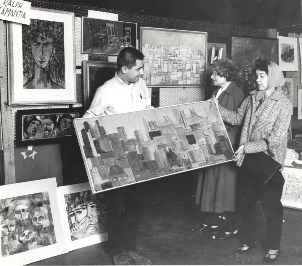 Women viewing paintings at an art exhibition