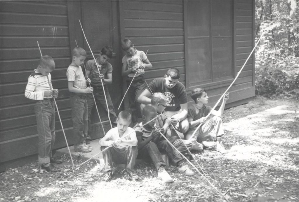 Campers making bamboo fishing poles