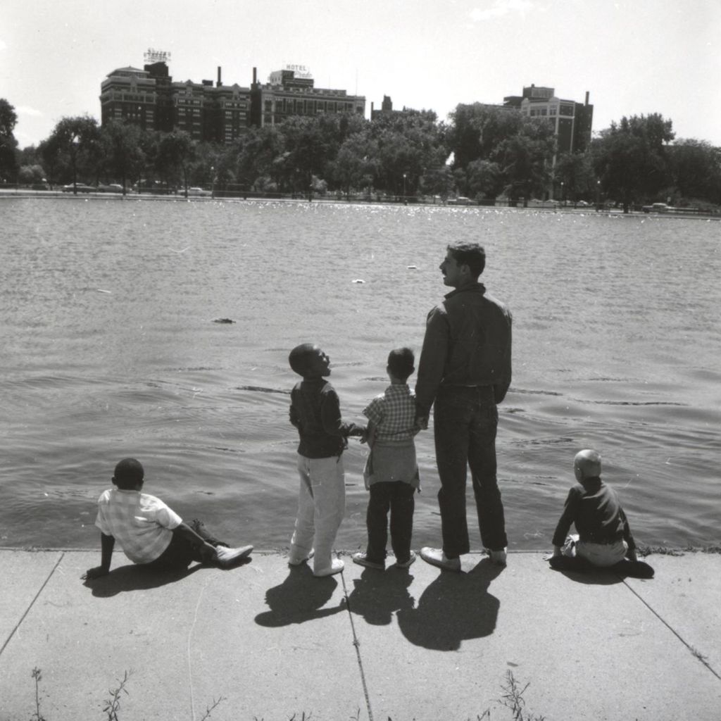 Boys and a man at the lakefront in Hyde Park