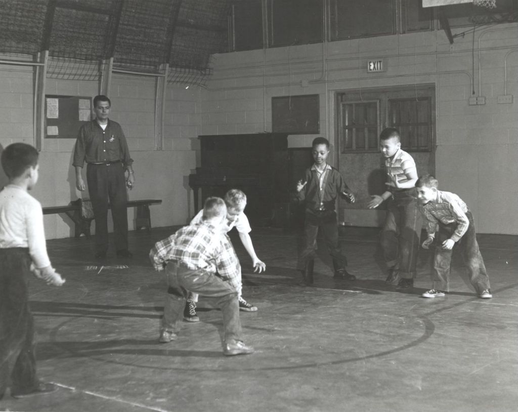 Boys wrestling in a gymnasium