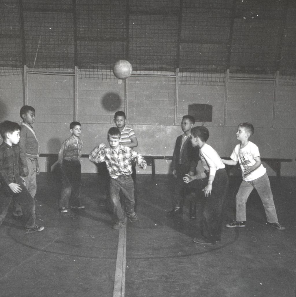 Boys playing ball game in gymnasium