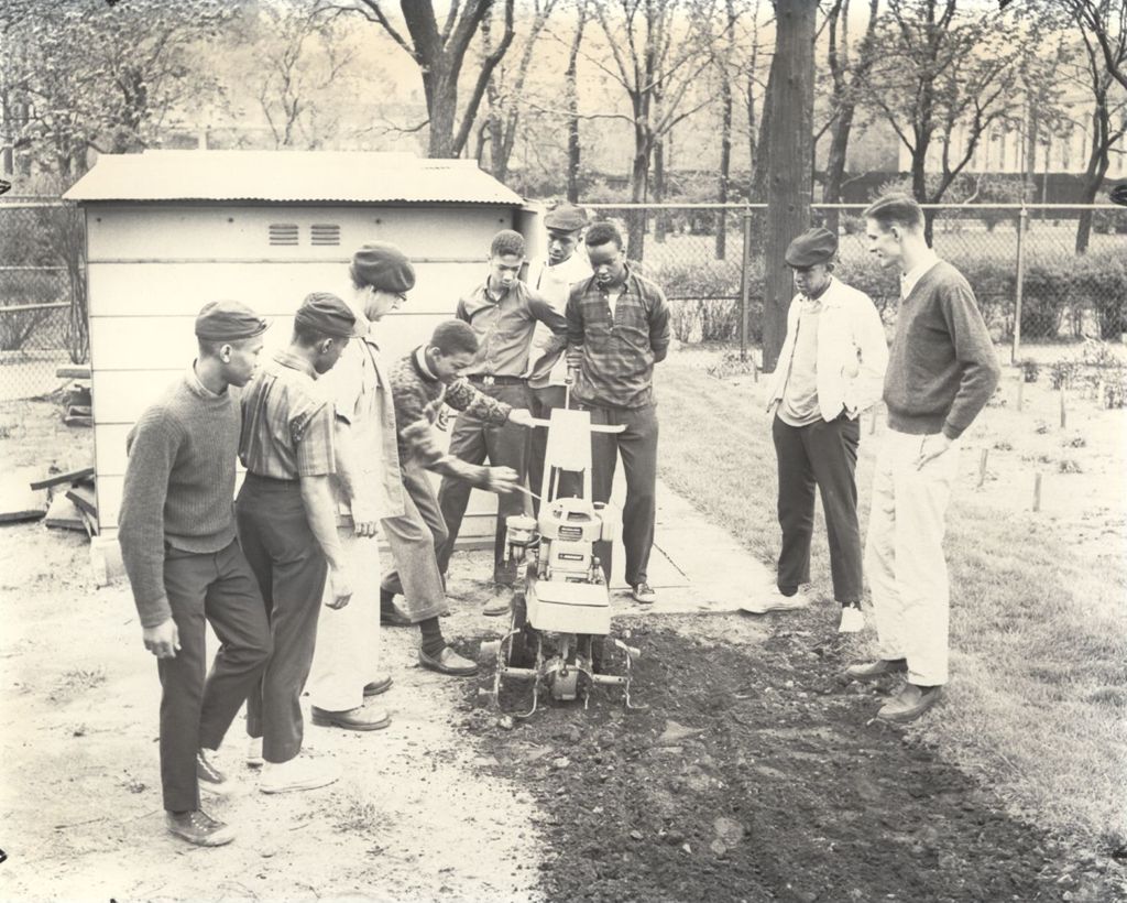 Miniature of Young men with a garden tilling machine in job-training program
