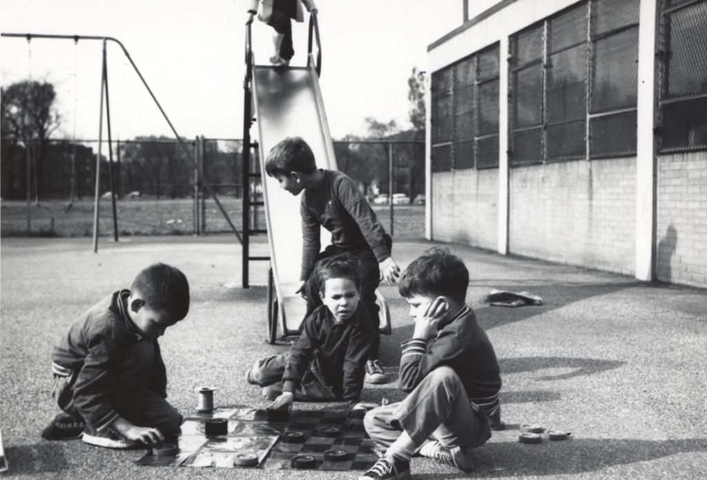 Boys playing Texas checkers in a playground