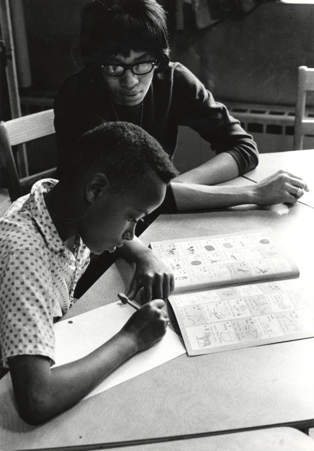 Woman tutoring a boy