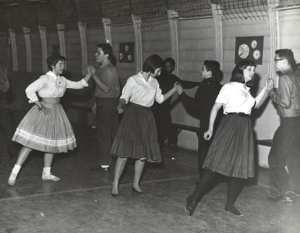 Teenage couples dancing in a gymnasium
