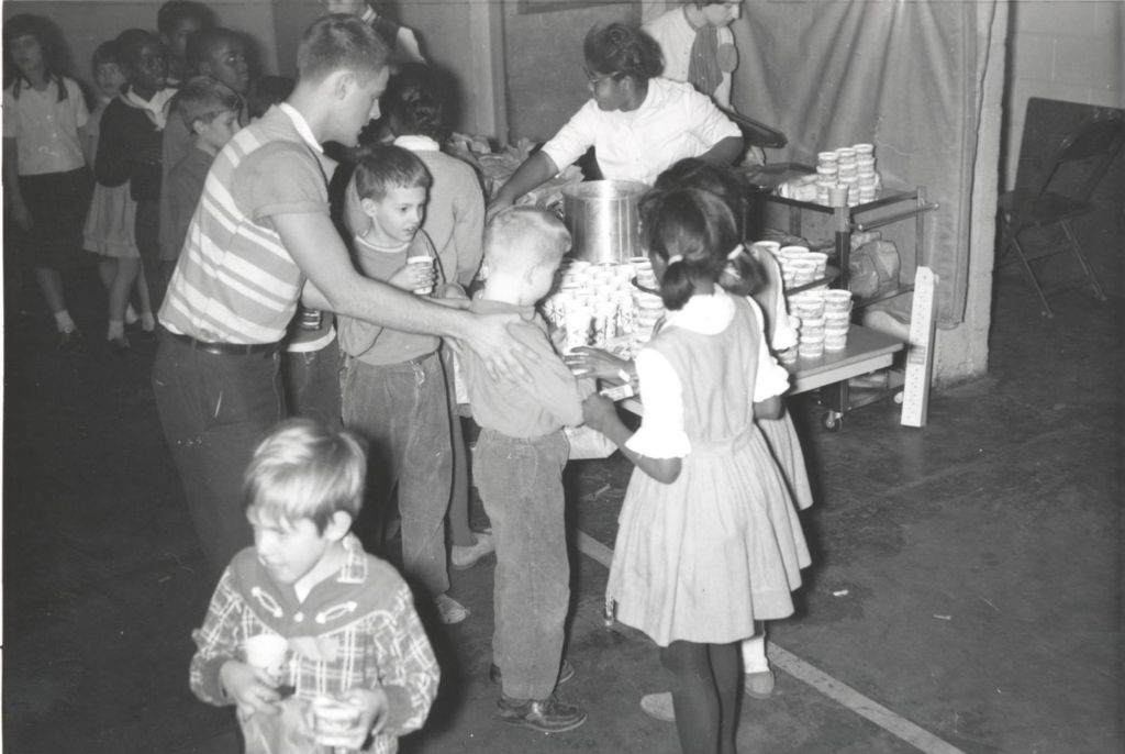 Children getting refreshments at Christmas party, Hyde Park Neighborhood Club