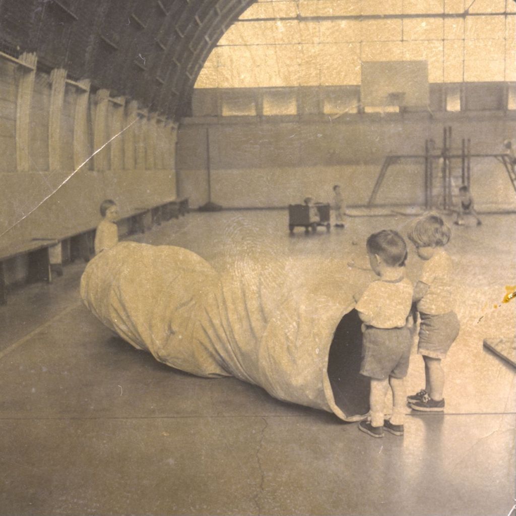 Young children with a recreational tube in a gymnasium
