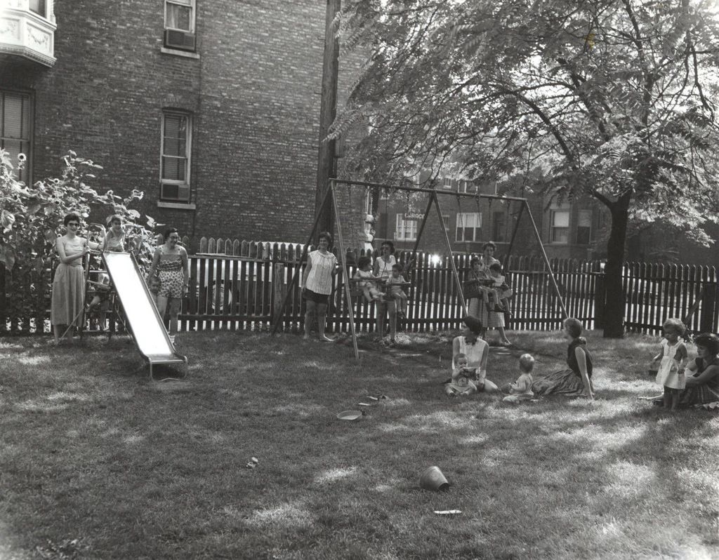 Mothers and children in a neighborhood play lot