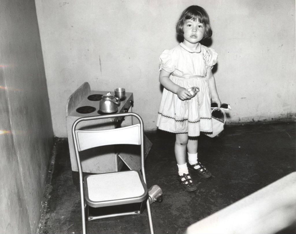 Young girl playing with a toy stove