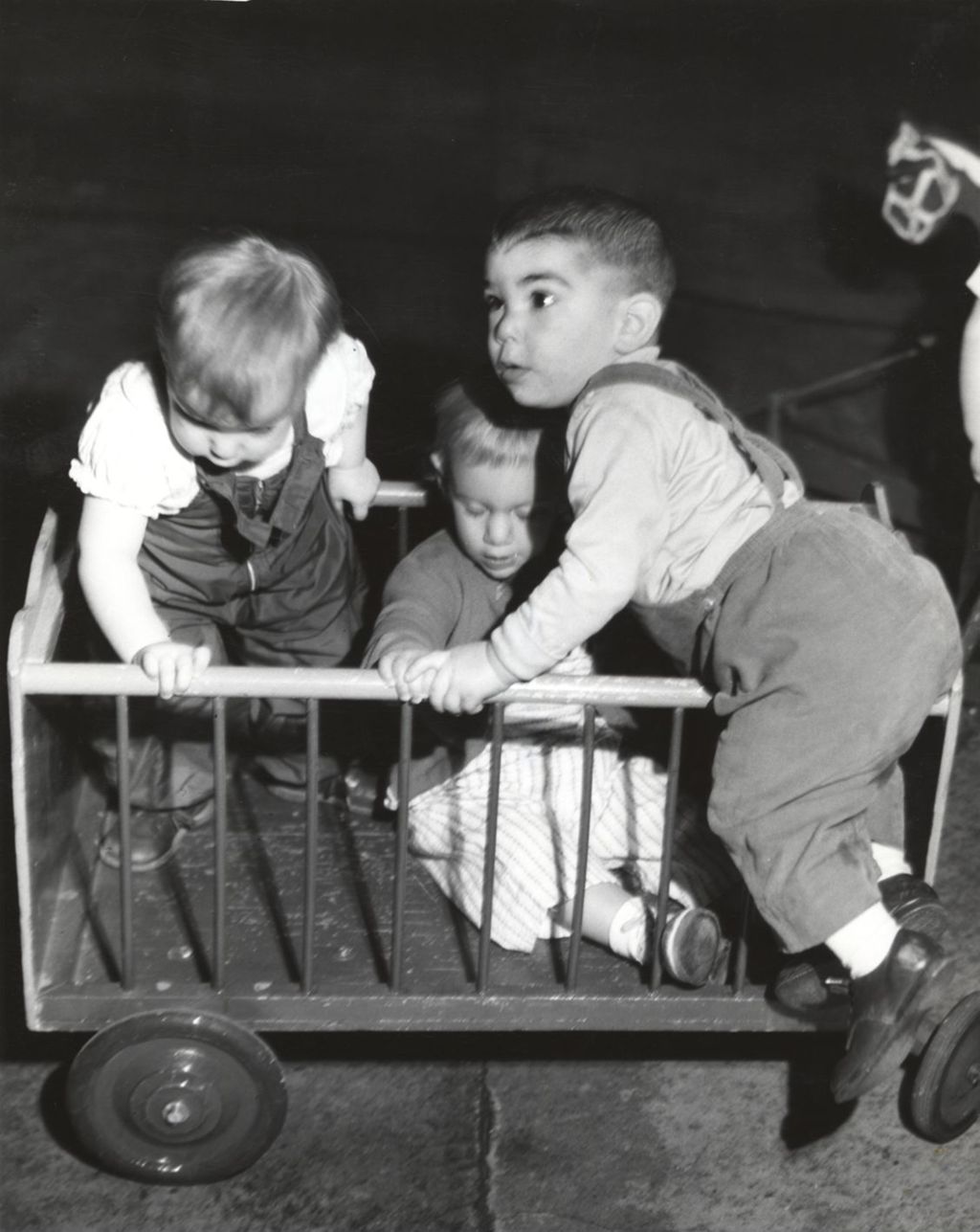 Boys playing on a small crib on wheels, Hyde Park Neighborhood Club
