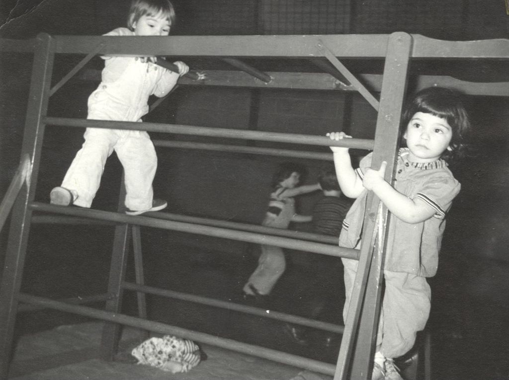 Children climbing a set of monkey bars