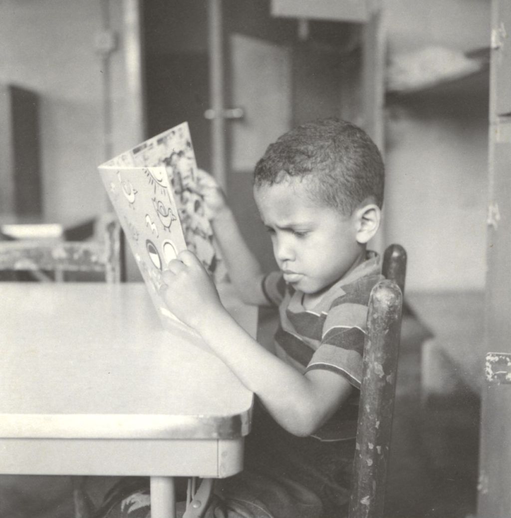 Miniature of Young boy reading a book