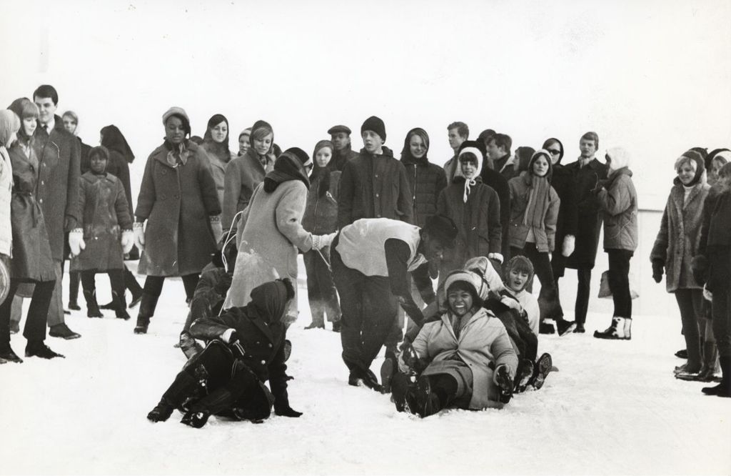 Young adults with a sled in the snow