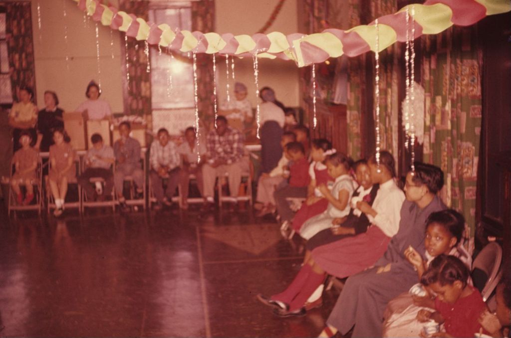 Children sitting on chairs for a party