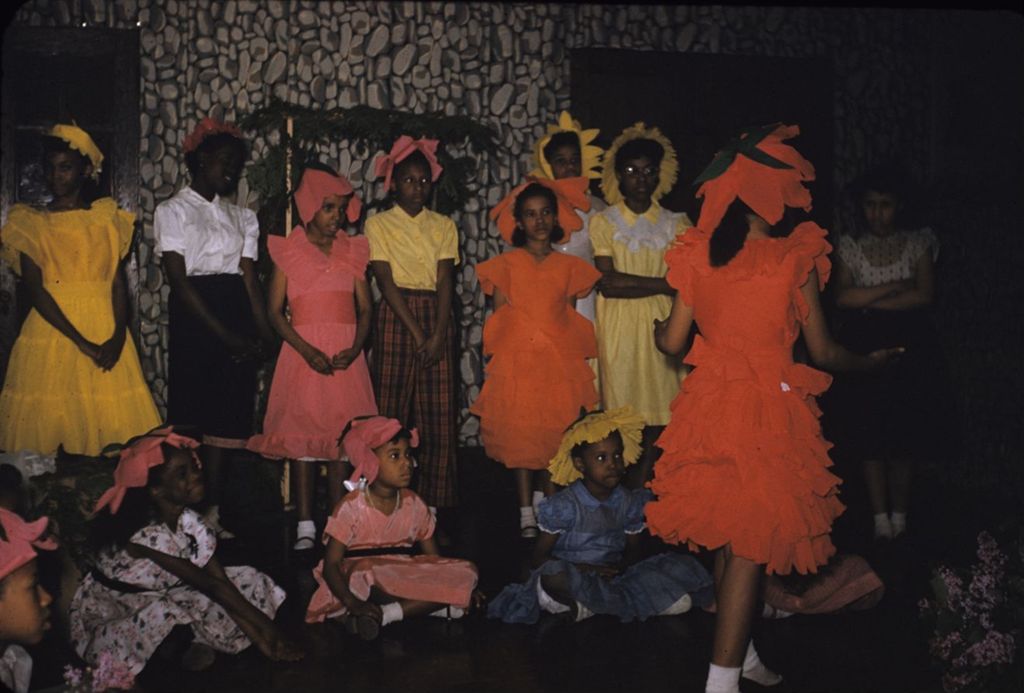 Teenage girls and children in colorful costumes