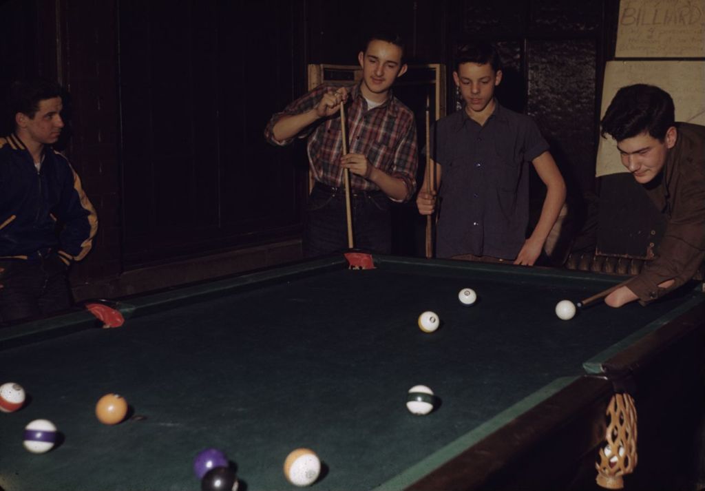 Teenage boys playing pool