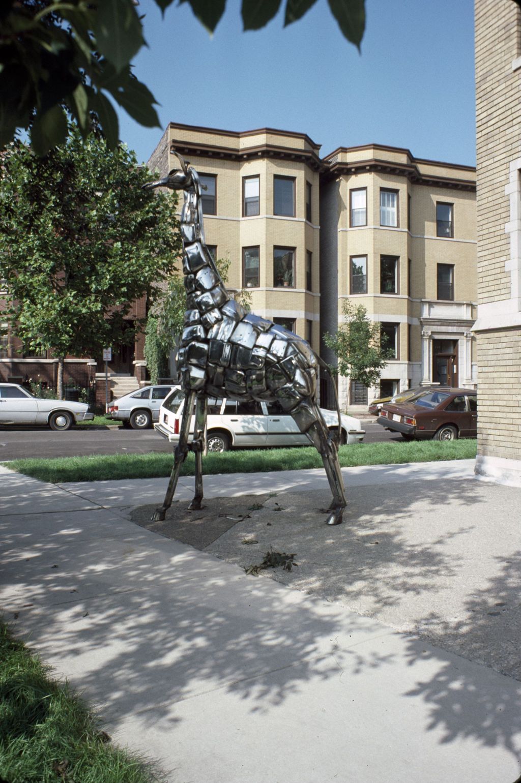 Giraffe sculpture and Cornelia Avenue apartments