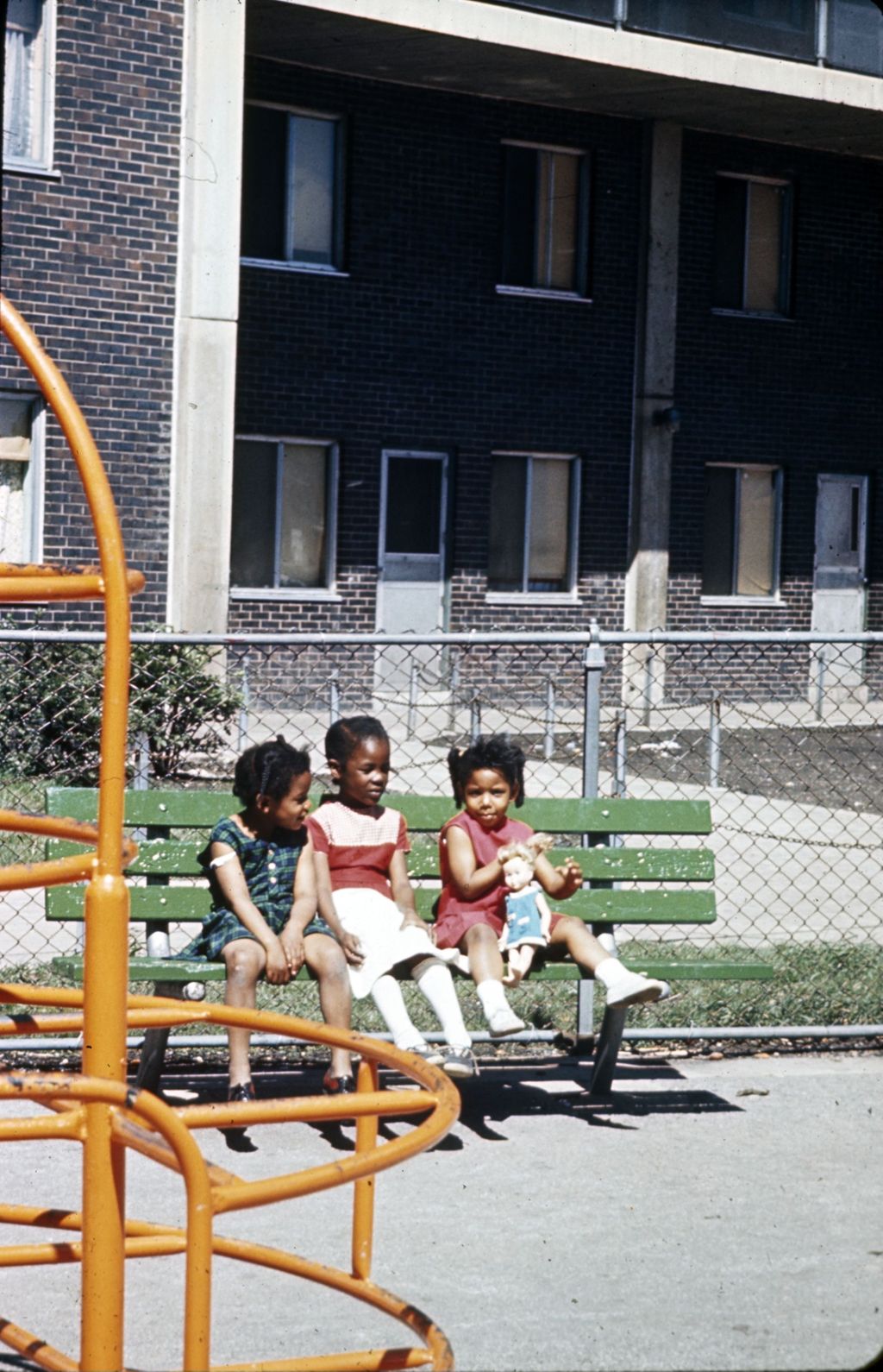 Children in playground next to apartment building