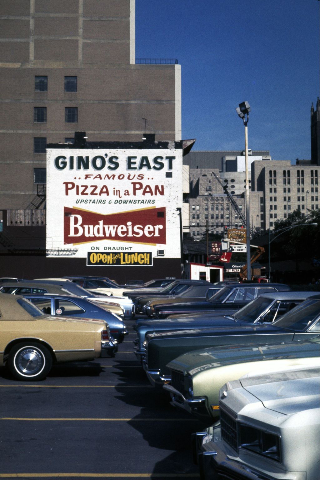 Gino's East pizzeria sign and parking lot