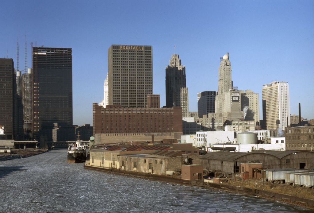 Storage facilities along the Chicago River with skyline behind