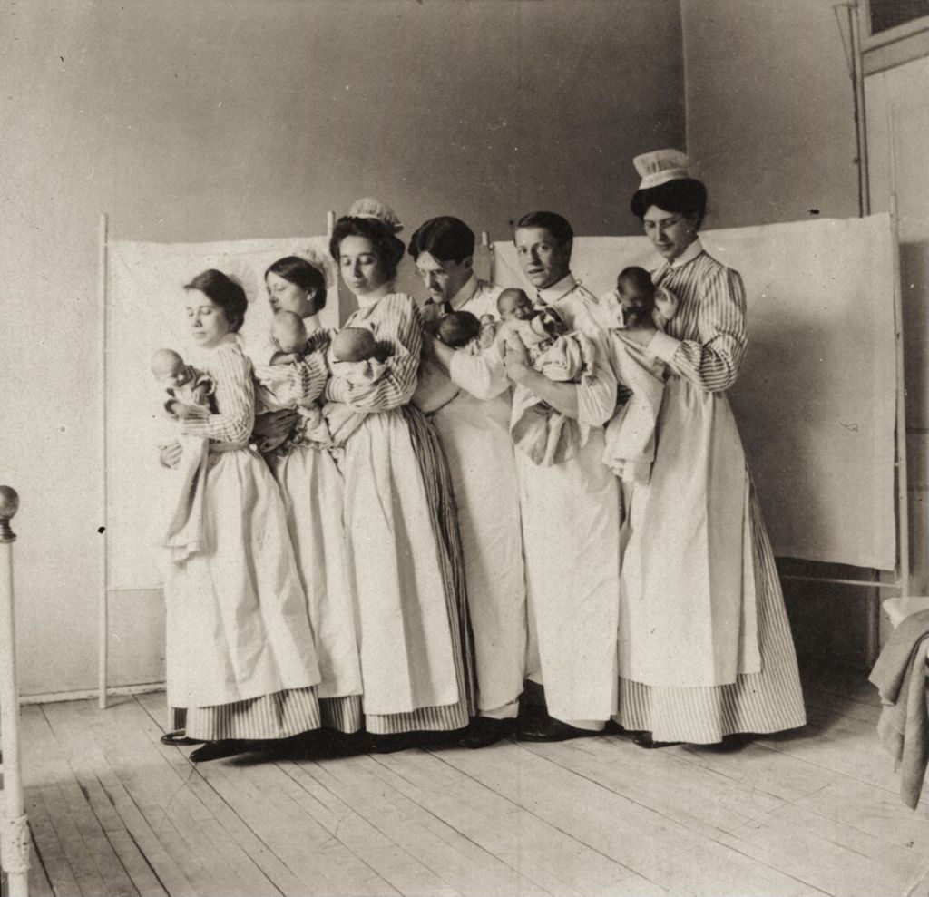 Nurses holding infants
