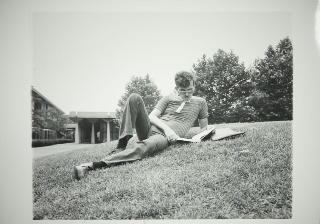 Miniature of Student reading on the lawn
