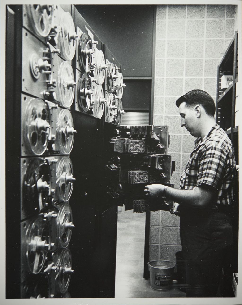 Miniature of Person with reel tapes, possibly for a computer