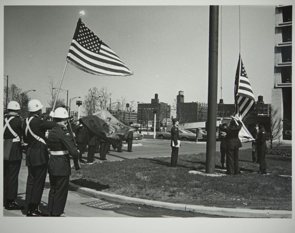 Miniature of Student Reserve Officer Training Corps (ROTC) members raising a flag on campus