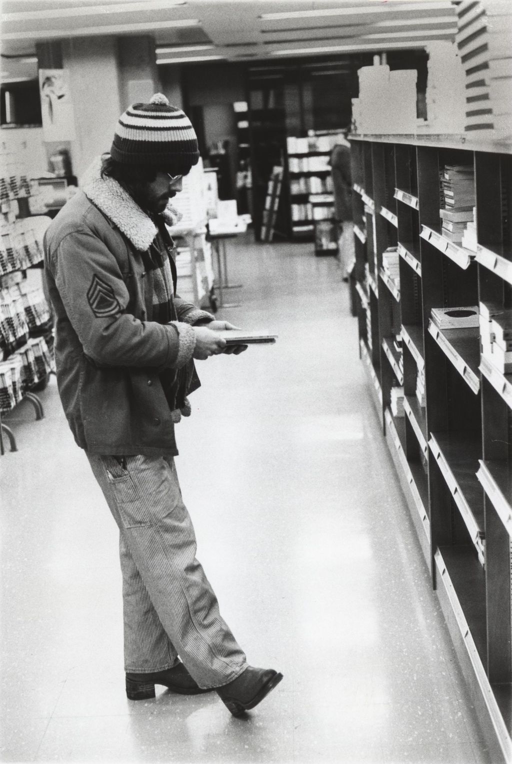 Miniature of Student looking for a book in the Campus Bookstore