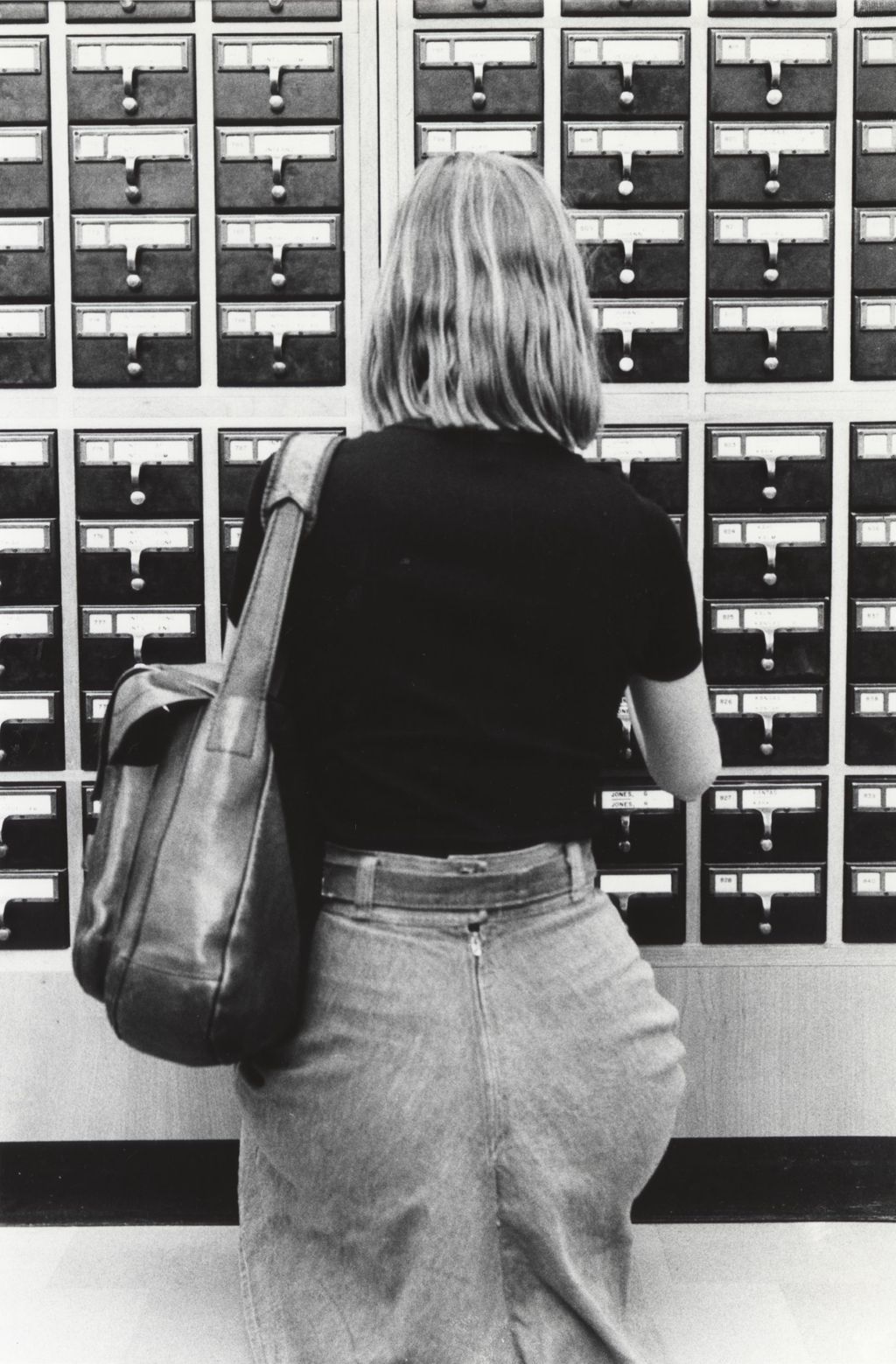 Student using a card catalog at the Richard J. Daley Library