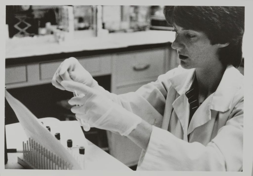 Miniature of Person filling test tubes at a research lab