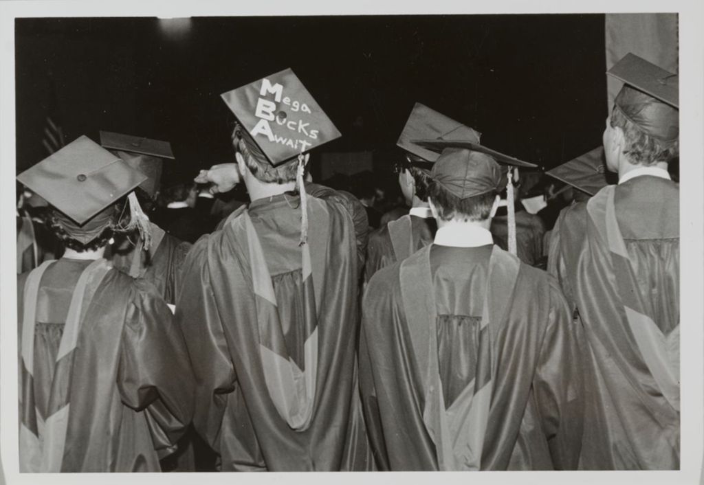 Students at the graduation ceremony, one with decorated mortarboard