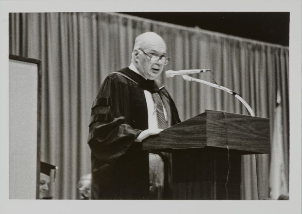 Miniature of Chancellor Donald H. Riddle addressing the audience at graduation