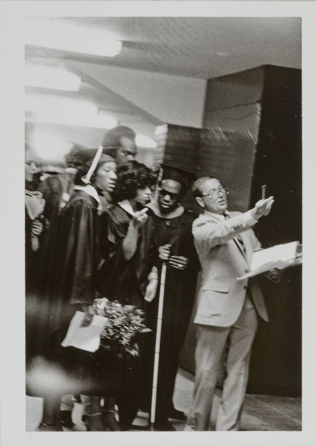 Miniature of Dean of the College of Kinesiology, Charles J. Kristufek, and graduating students at graduation