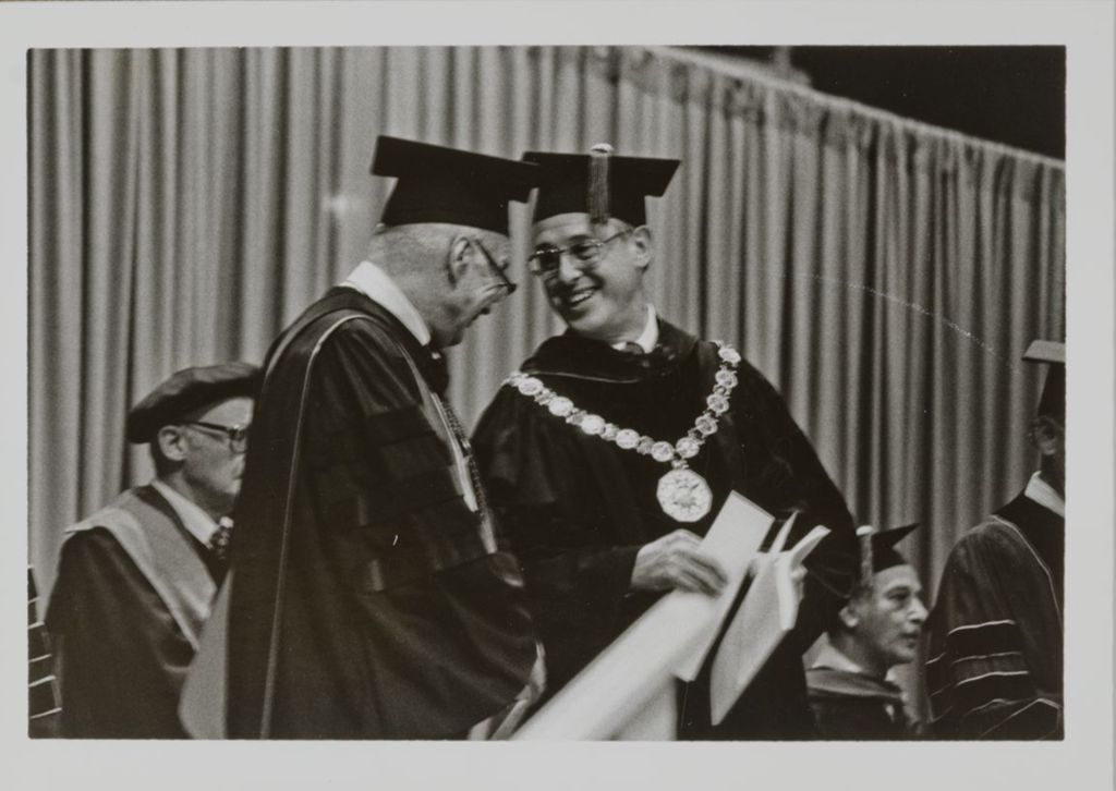 Miniature of Donald H. Riddle and Stanley O. Ikenberry at the graduation ceremony