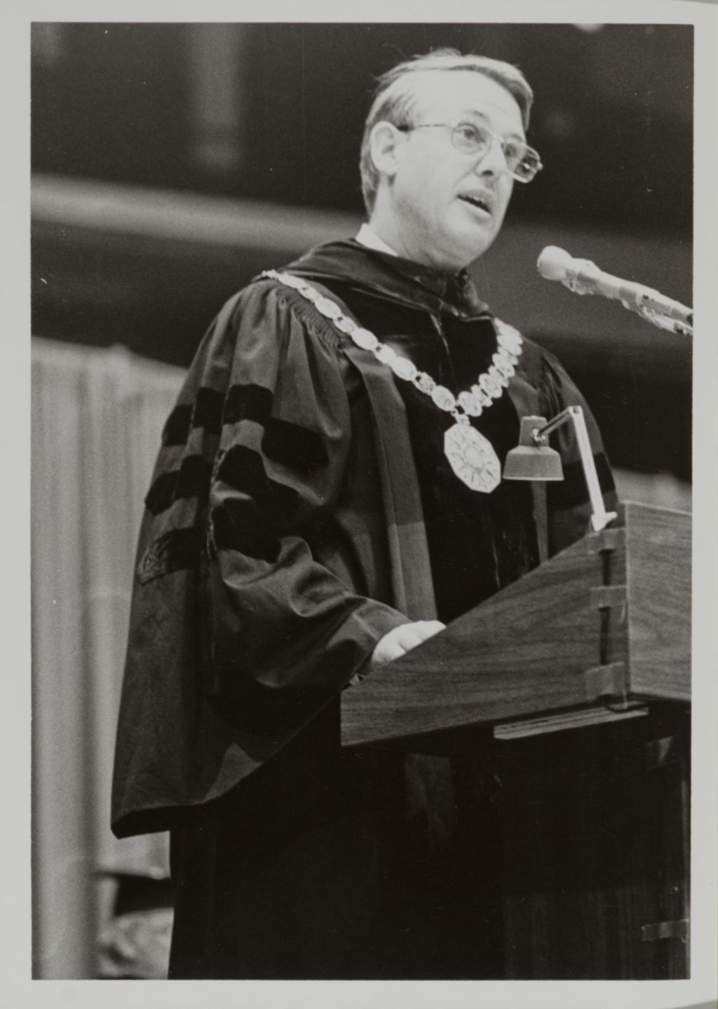 Miniature of University of Illinois President Stanley O. Ikenberry addressing the audience at graduation