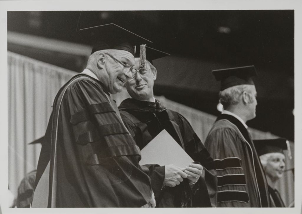 Miniature of University of Illinois President Stanley O. Ikenberry (center) and unidentified people at the graduation ceremony