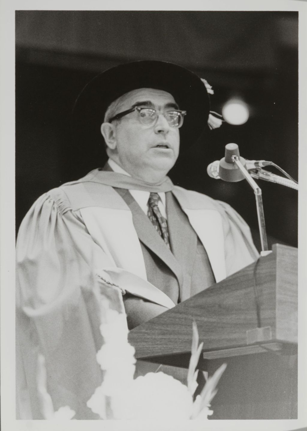 Miniature of Faculty member at the podium during the graduation ceremony