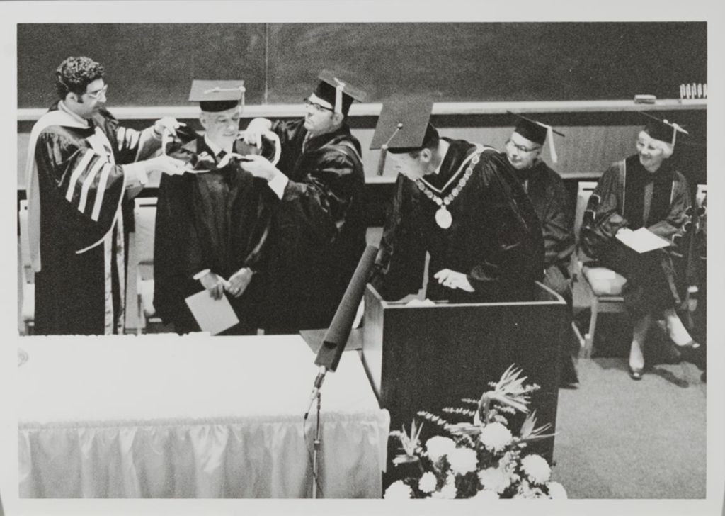 Miniature of Faculty members and honorary degree recipient on stage during the graduation ceremony
