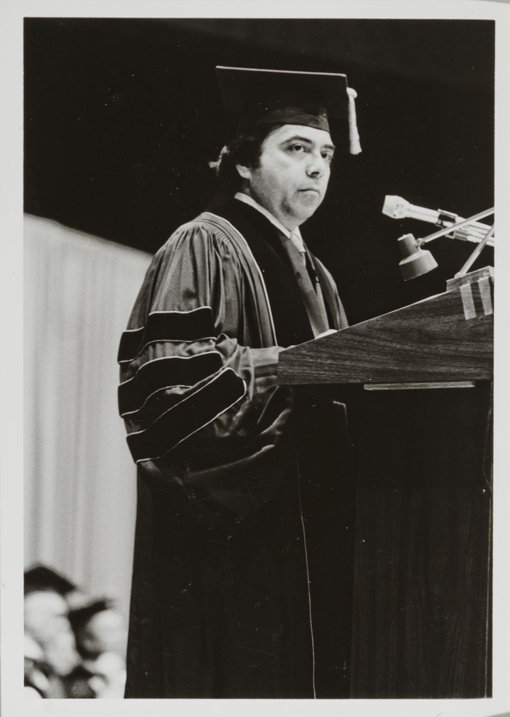 Faculty member at the podium during the graduation ceremony