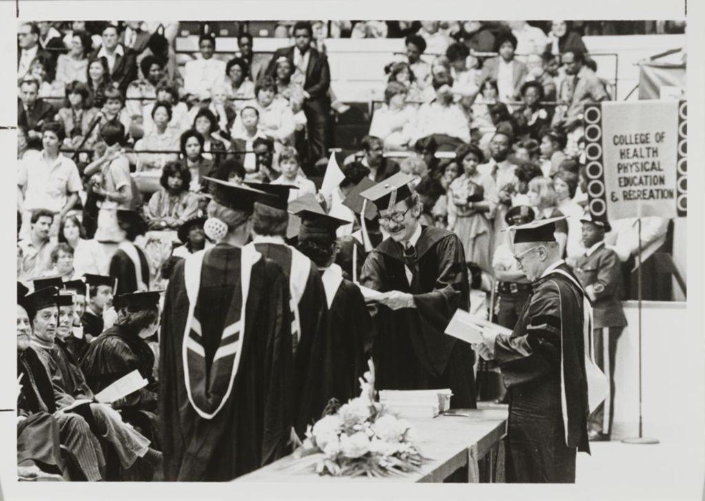 Faculty members on stage during the graduation ceremony