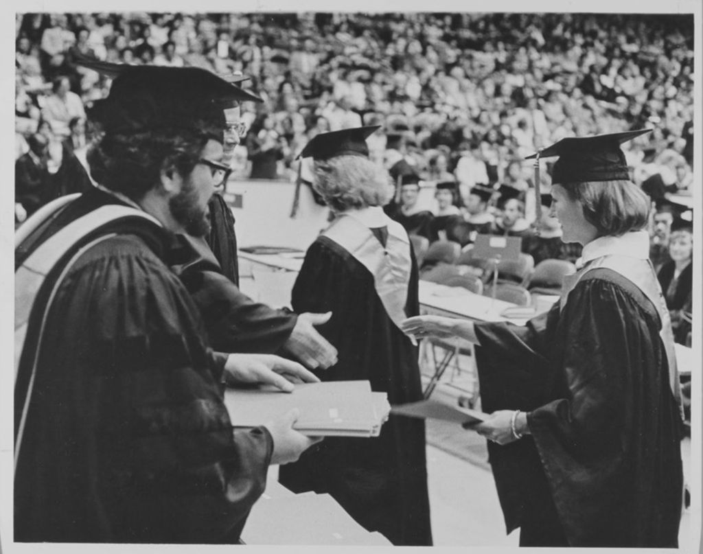 Students receiving their diplomas at the graduation ceremony