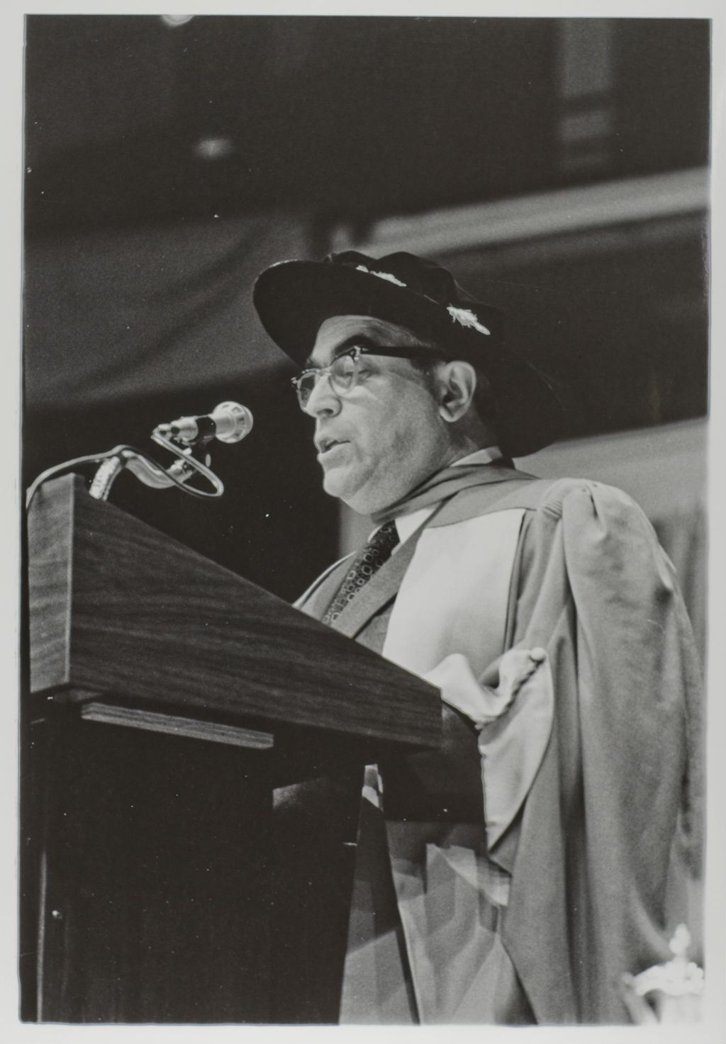 Person speaking at the podium during the graduation ceremony