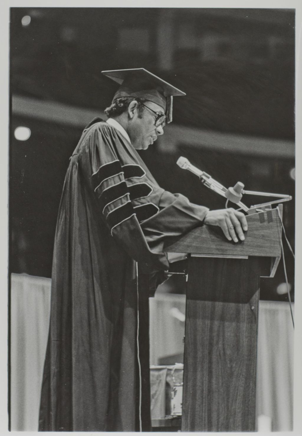 Person speaking at the podium during the graduation ceremony