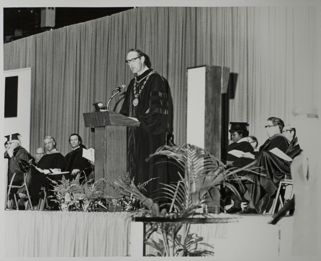 University of Illinois President John E. Corbally at the podium, graduation ceremony