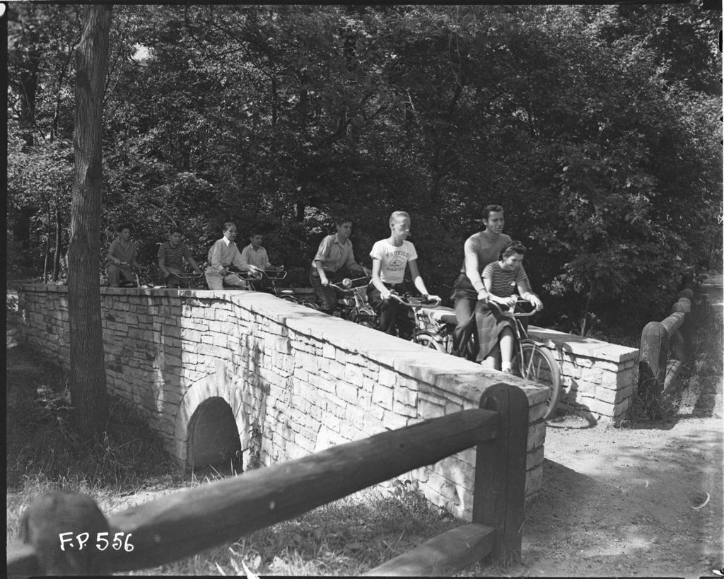 Bicyclists riding over bridge